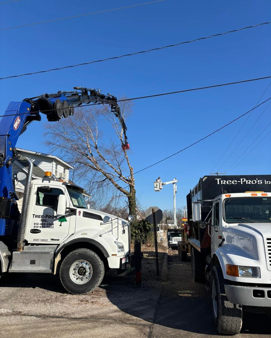 Two boom trucks parked close in for a lift