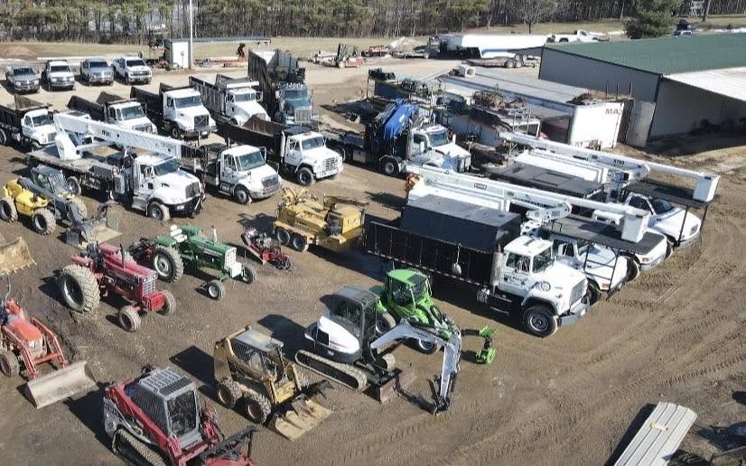 Excavators, skid steers and forestry equipment in the Tree Pros yard