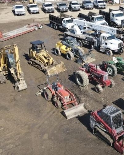 Excavators, skid steers and forestry equipment in the Tree Pros yard